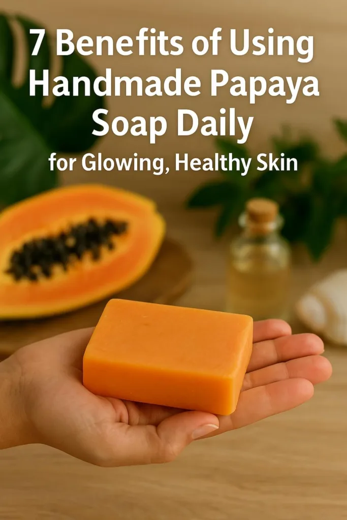 Close-up of handmade papaya soap held in hand, surrounded by tropical leaves and organic beauty elements