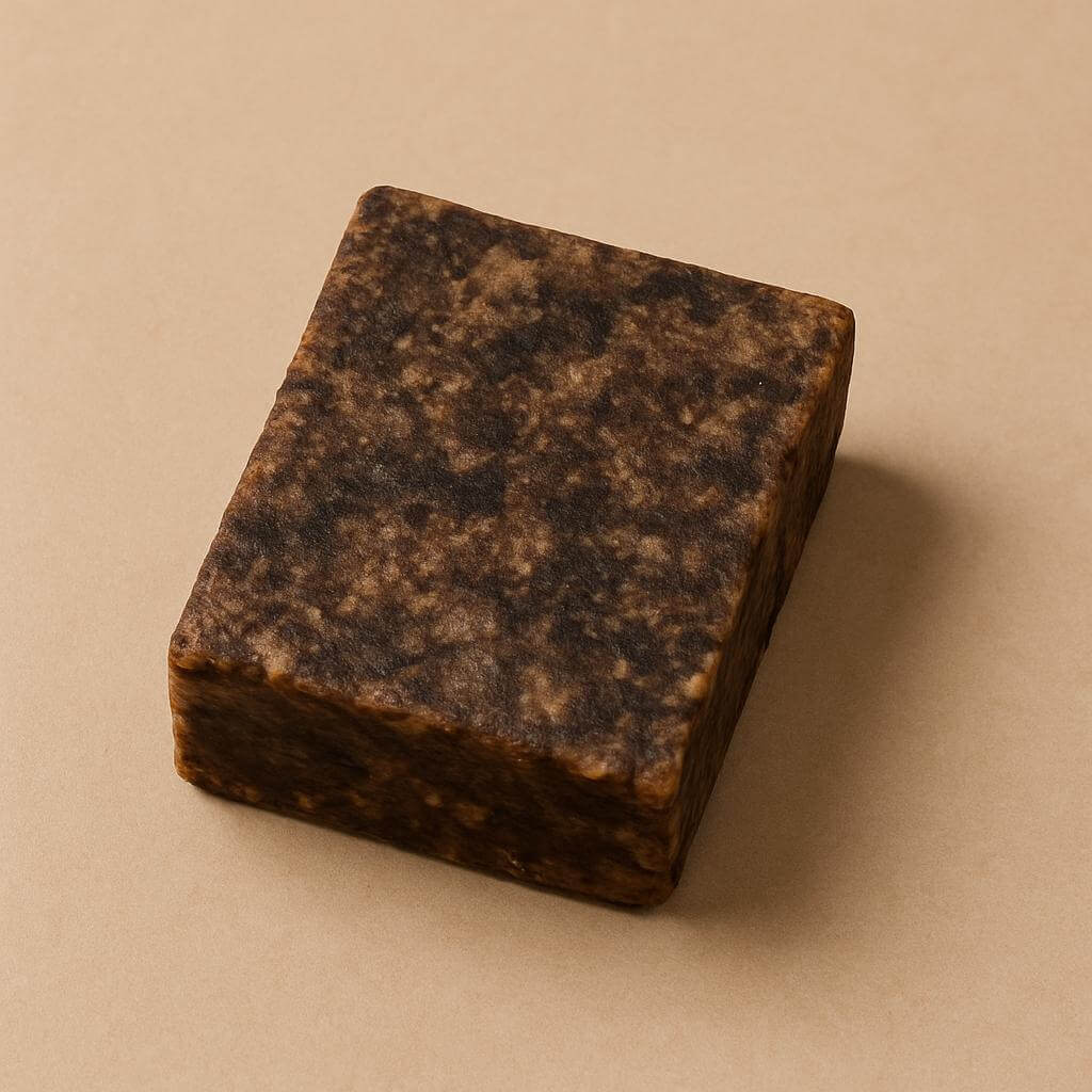 Pure African Black Soap bar on a wooden dish for natural skincare benefits