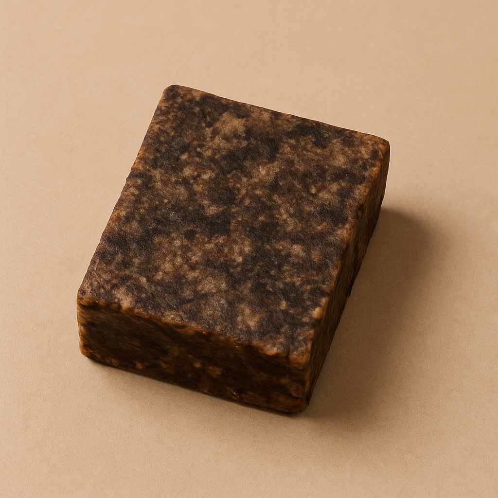 Close-up image of Shea Moisture African Black Soap with Shea used in a skincare routine